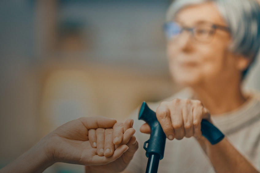 senior woman being helped by caregiver