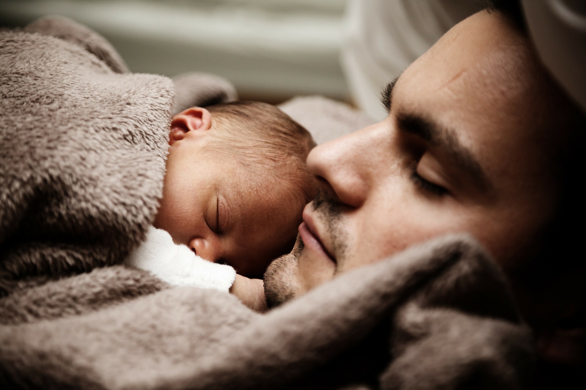 Sleeping father and infant