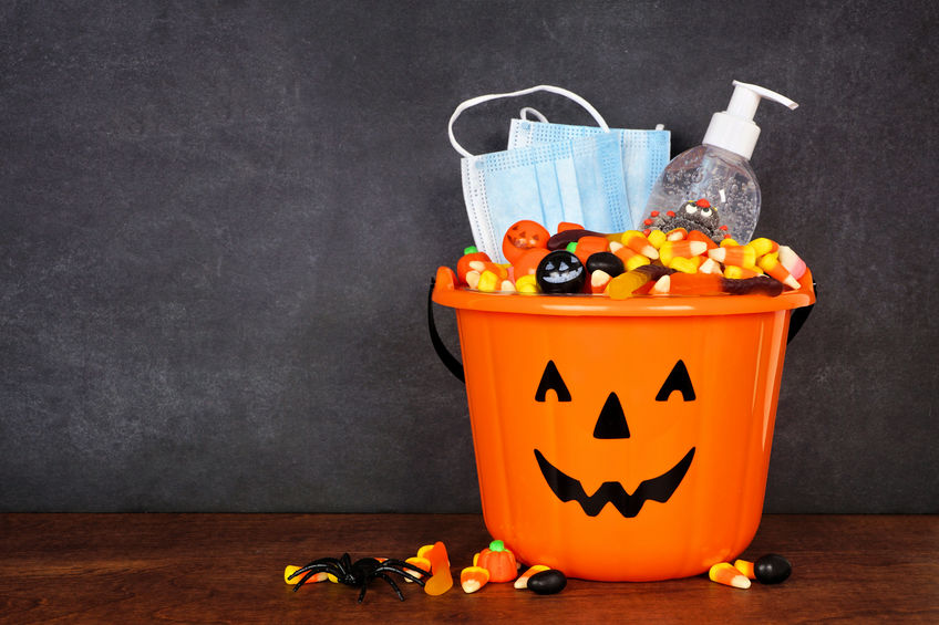 Halloween Jack-o-lantern Bucket with candy corn, face masks, and hand sanitizer