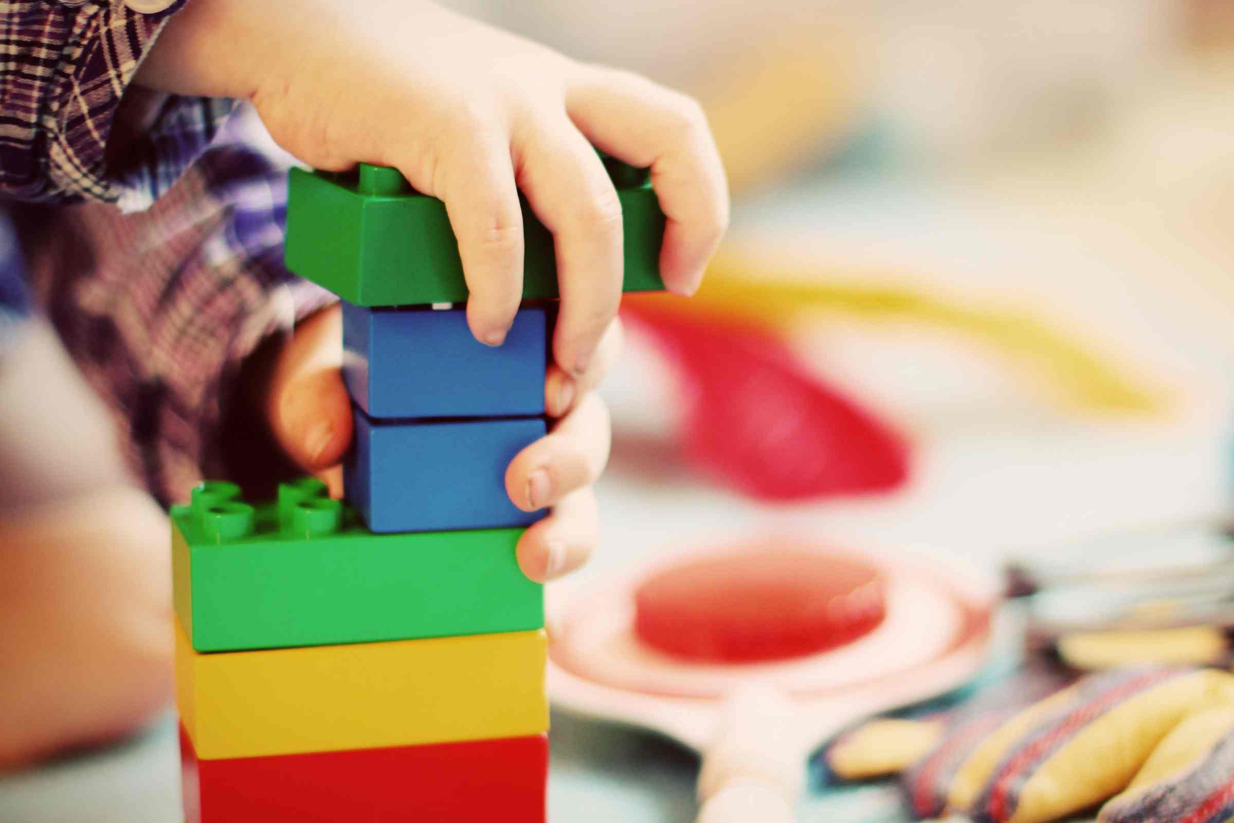child is playing with colorful blocks