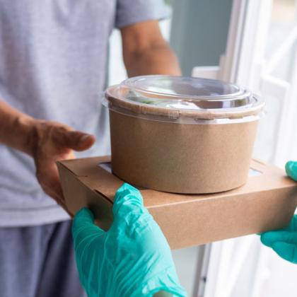Person receiving delivery of food with personal protective equipment