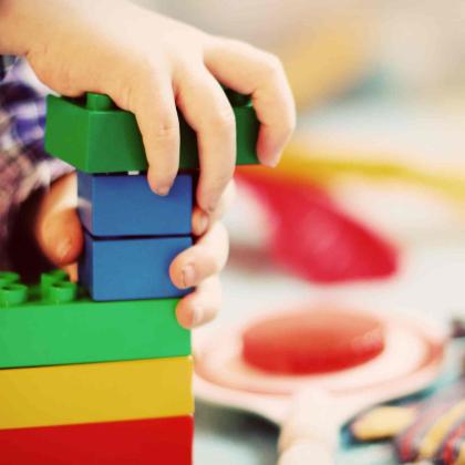 child is playing with colorful blocks