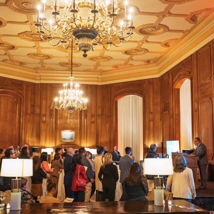 Expanded shot of the California Club with attendees listening to speaker