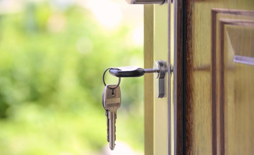 Keys in open door representing housing