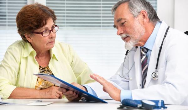 doctor explaining paperwork to woman client