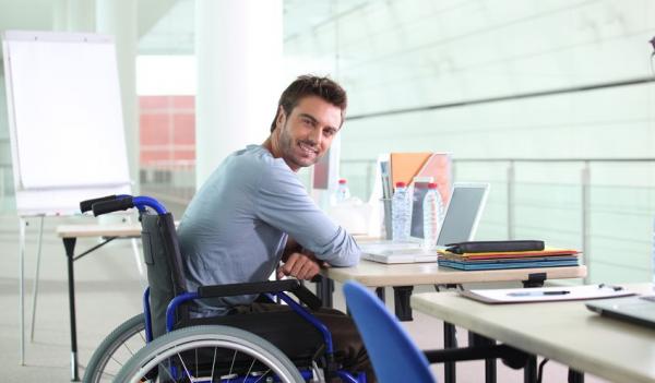 young adult male in wheelchair at desk